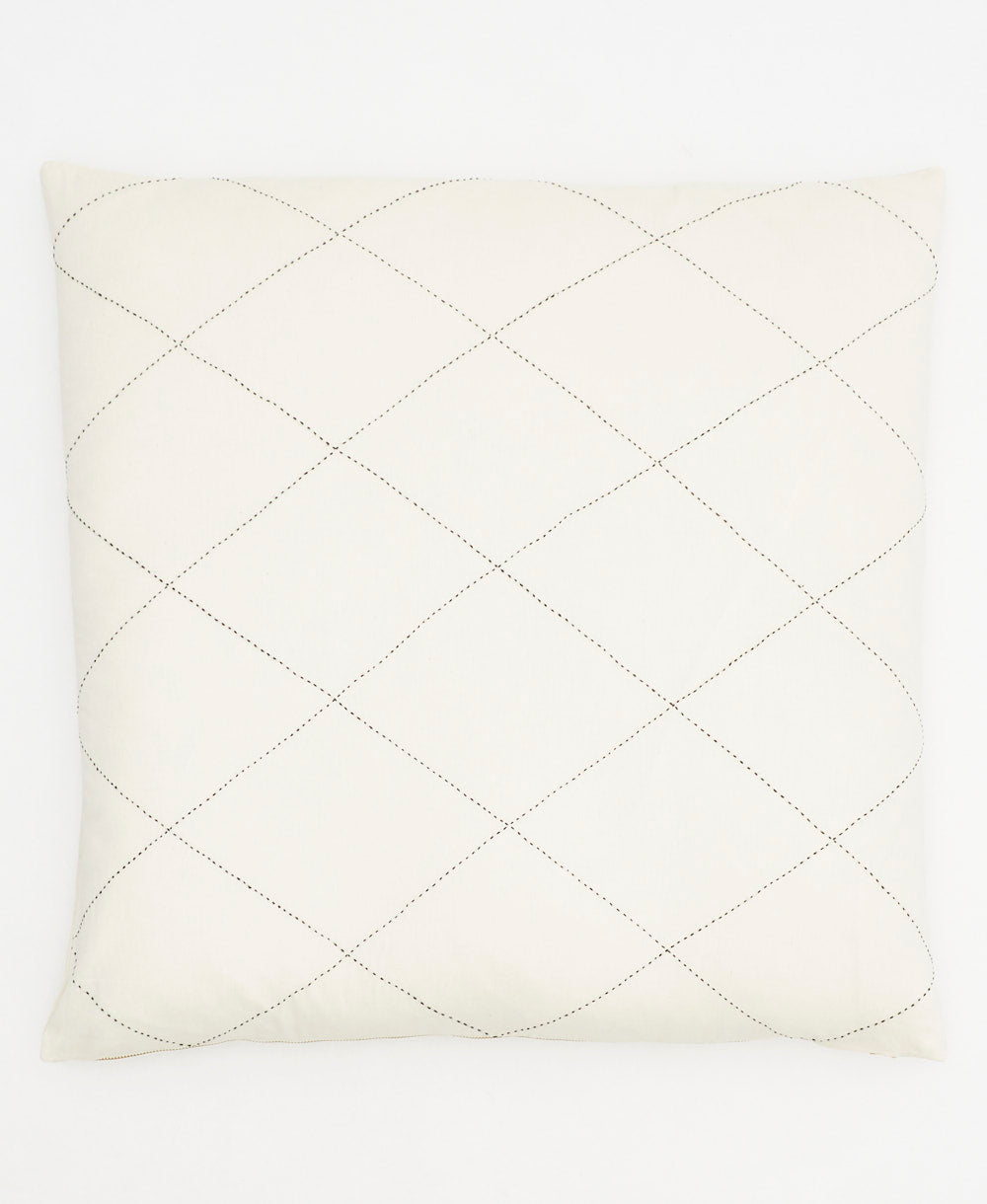 Quilted pillow with diamond pattern on a white background