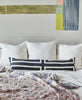 all white organic cotton embroidered euro shams with abstract wall mural in pastel colors
