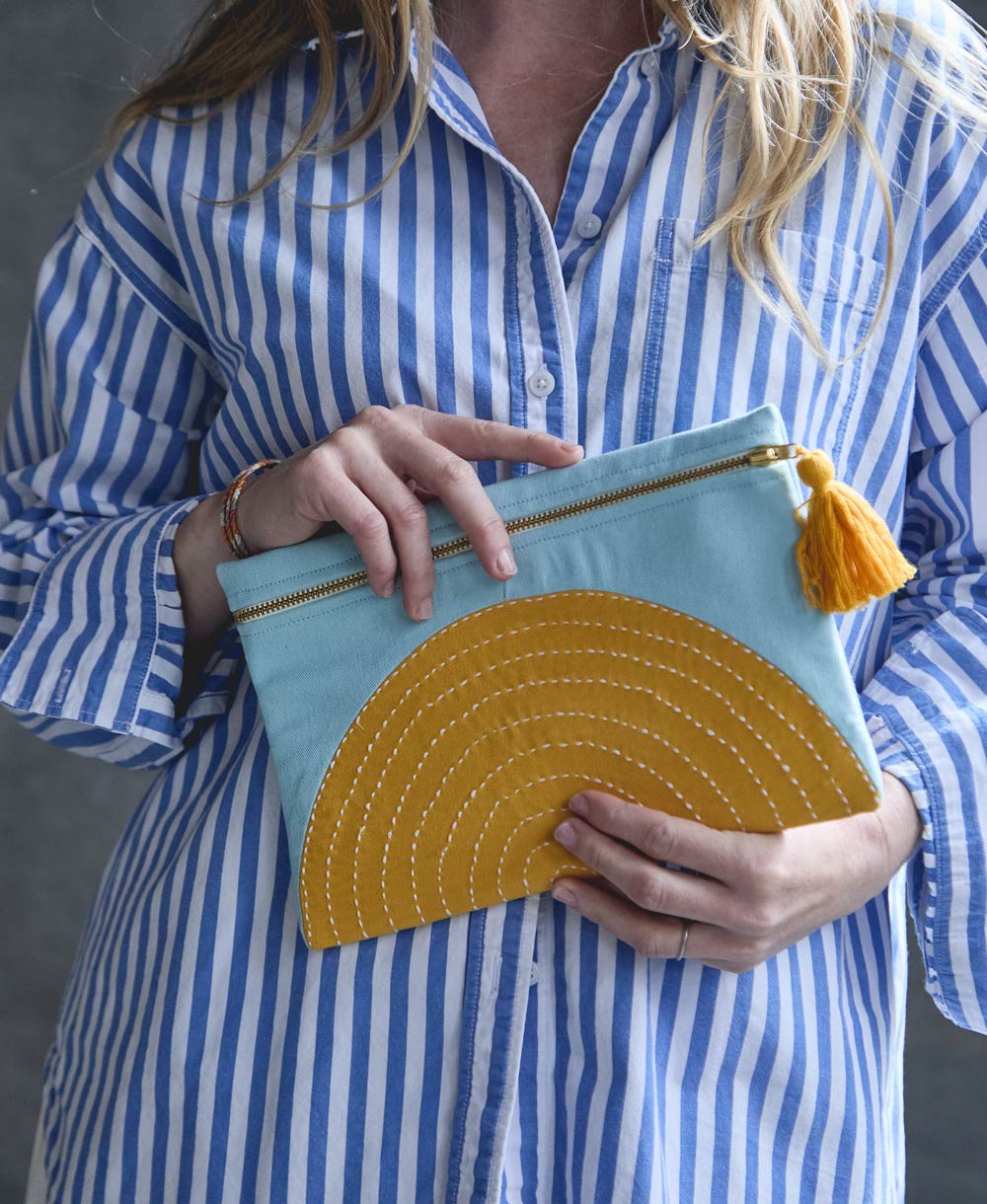 sky blue and mustard yellow pouch in half moon crescent design with hand-stitched embroidery