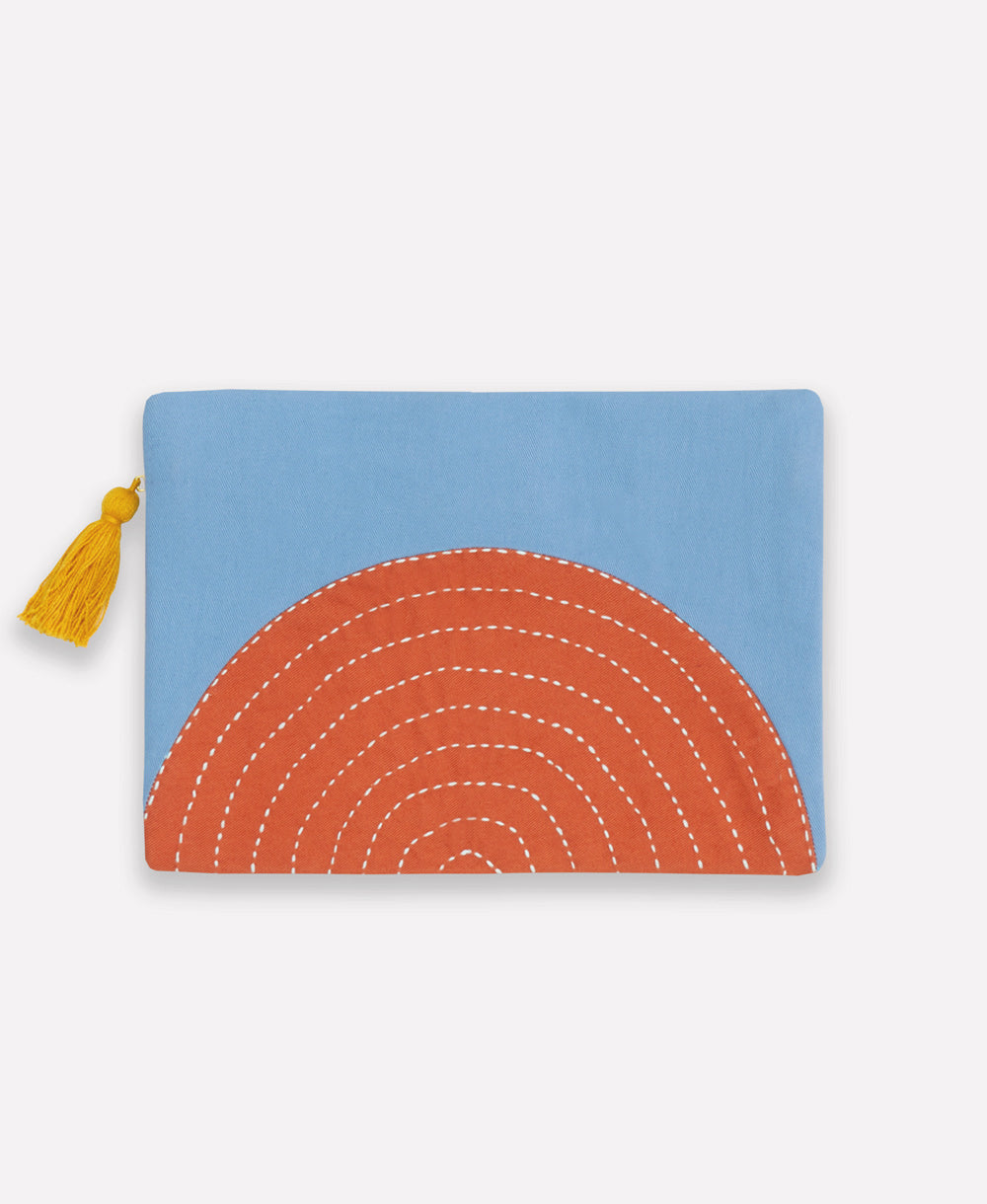 small pouch in sky blue and orange design with mustard yellow tassel and white hand-stitched embroidery