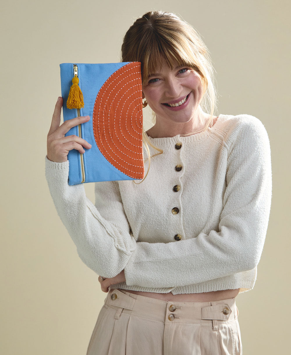 sky blue pouch with range half moon design with mustard yellow tassel