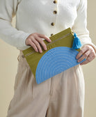 olive green pouch with sky blue half moon design and cobalt blue tassel