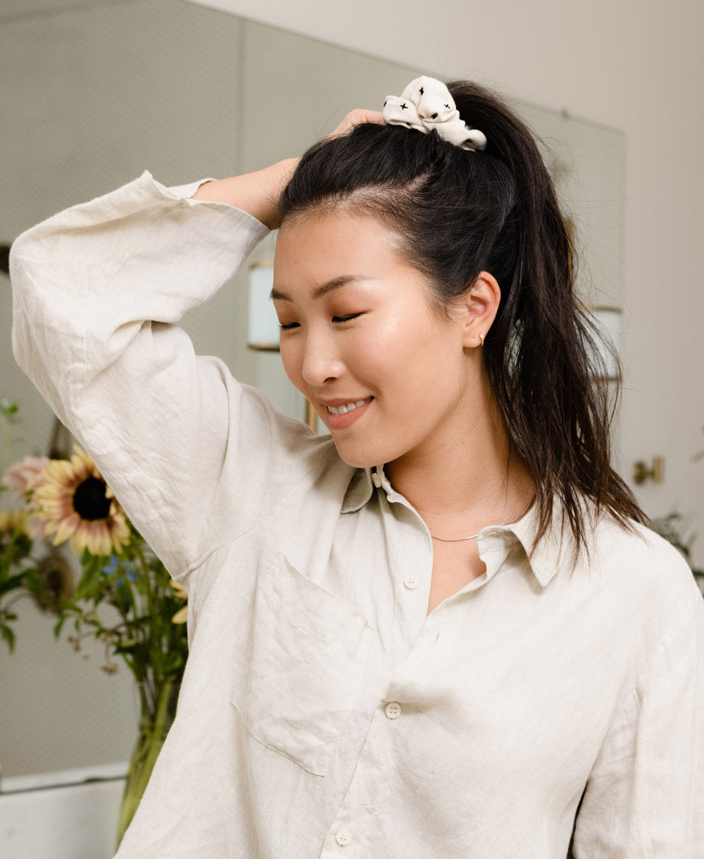 woman wearing high ponytail with organic cotton white scrunchie