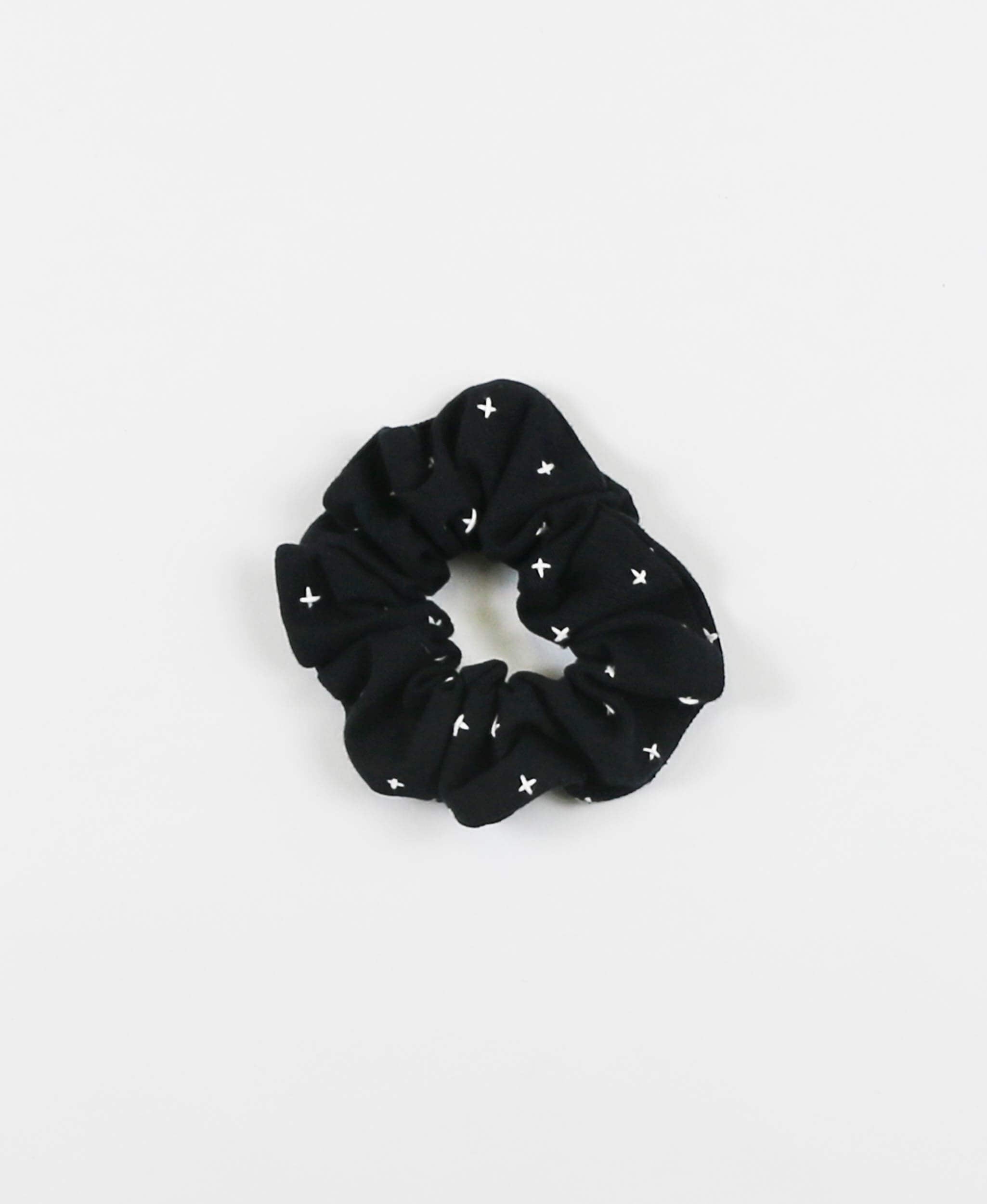 black organic cotton scrunchie with white hand-stitched embroidery