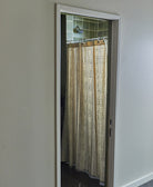 Open door leading to a bathroom with a shower curtain