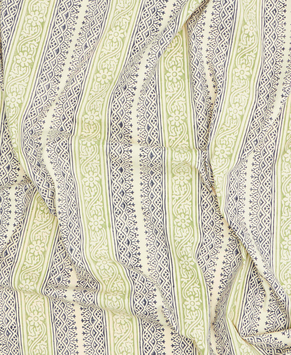 Close-up of a fabric with intricate green and beige pattern