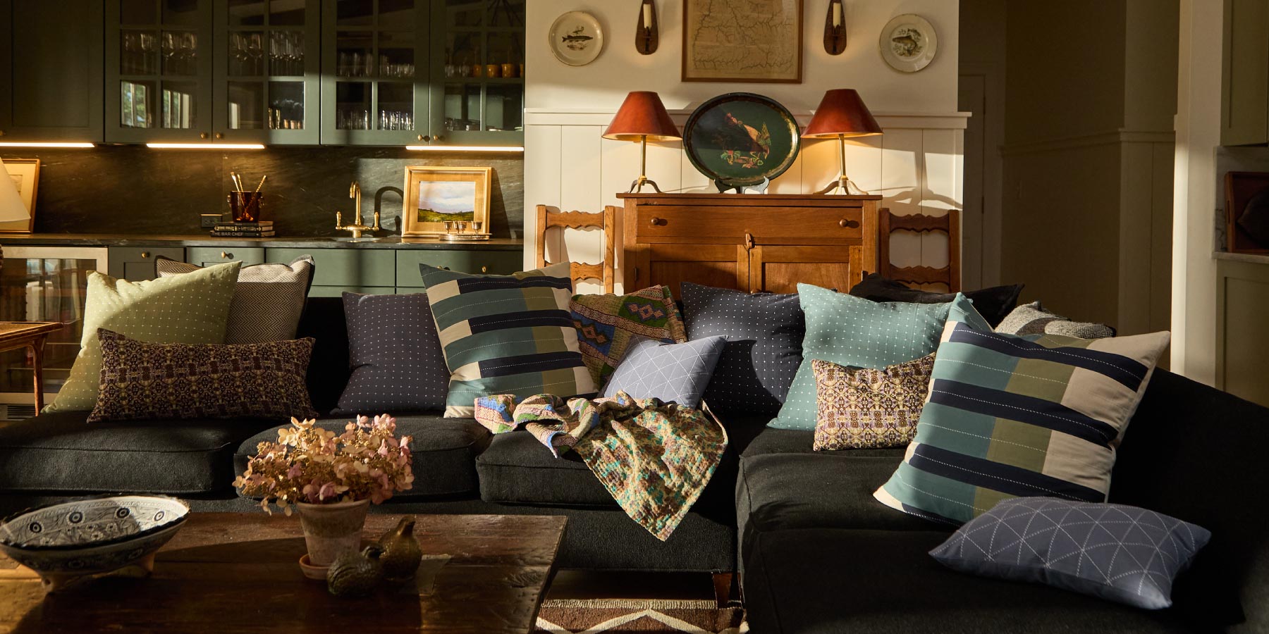 Living room with a dark sofa adorned with modern throw pillows, a coffee table, and decorative items