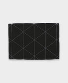 black cotton placemat with white hand-stitched embroidery