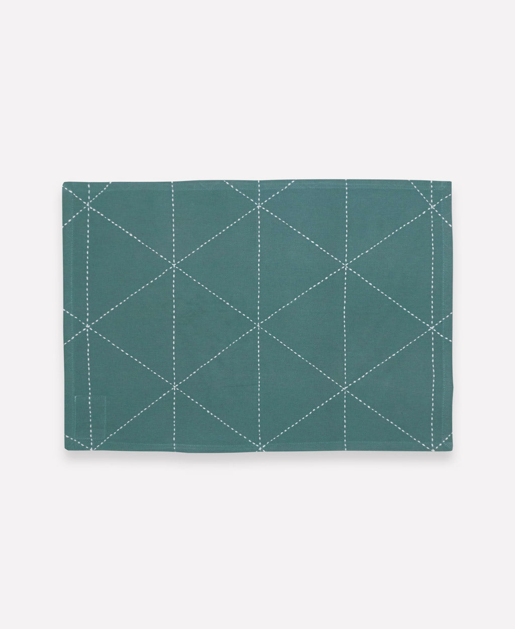 spruce green cotton placemat with white triangle stitch embroidery
