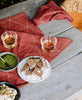 outdoor fall table setting featuring rust cotton table linens