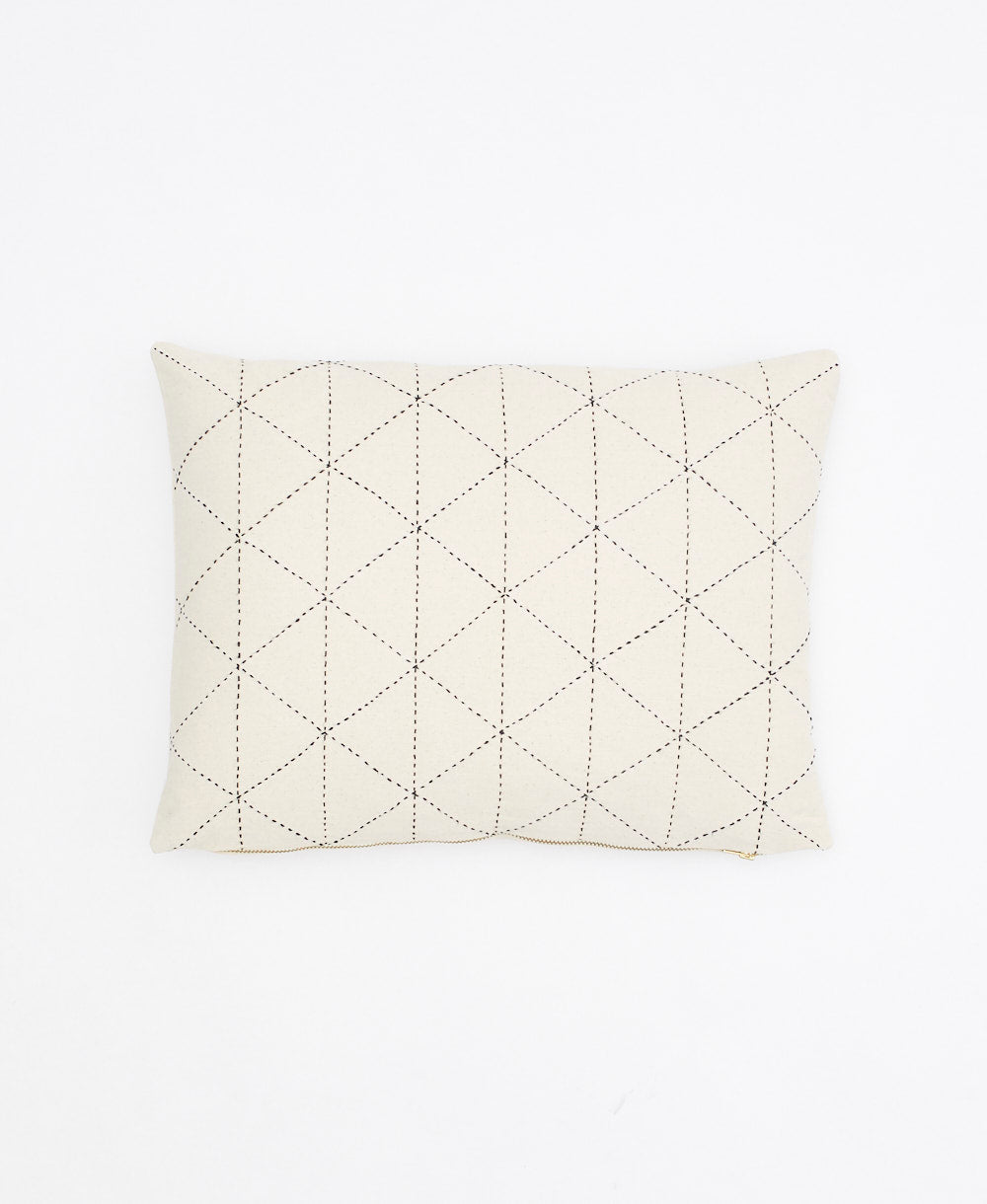Quilted pillow with diamond pattern on a white background