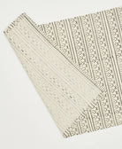 Decorative fabric with intricate patterns on a white background
