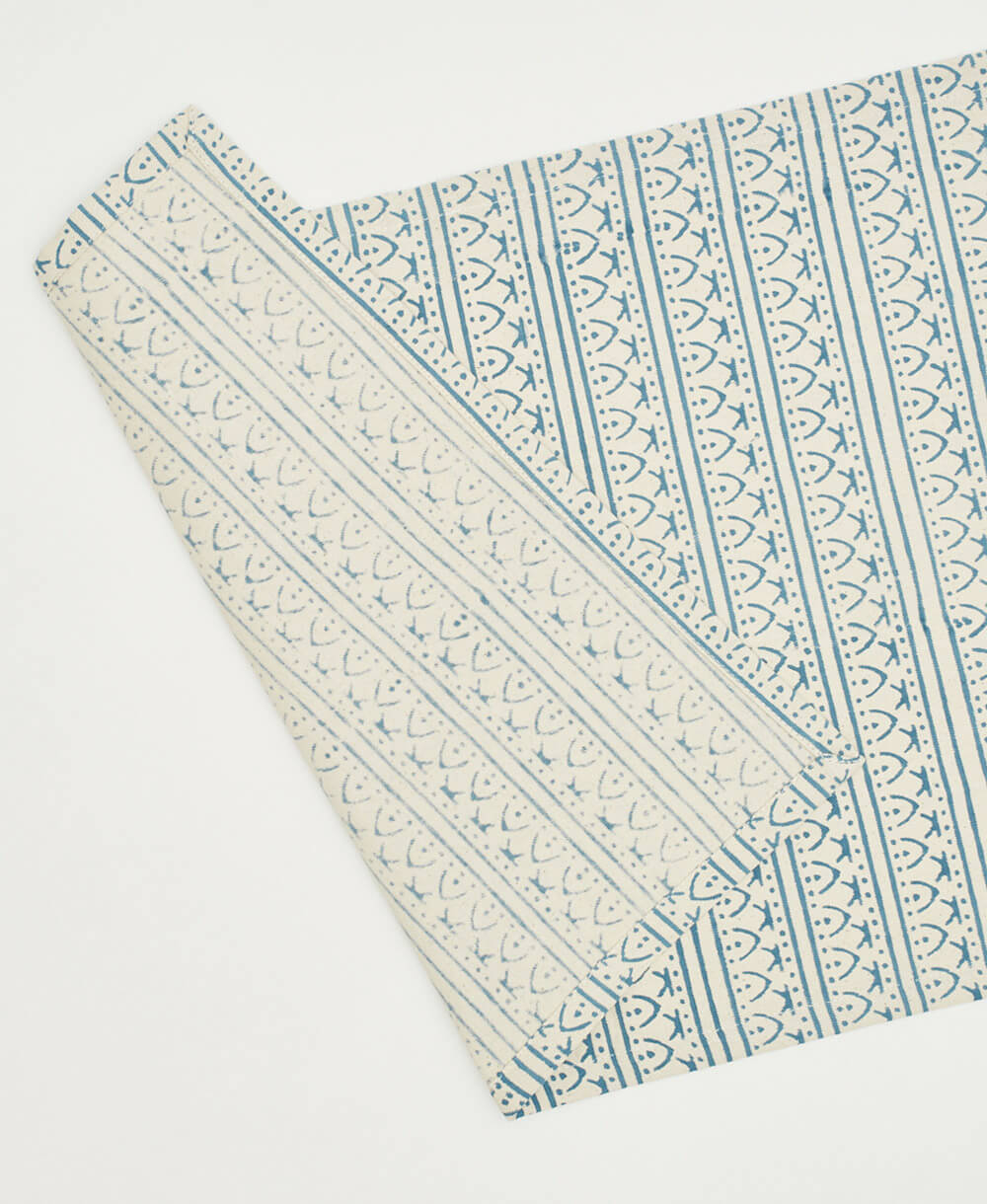 Patterned fabric with blue and white design on a white background