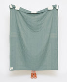 Green fabric draped over a white frame on a white background