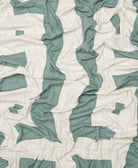 Close-up of a quilt with green and white pattern