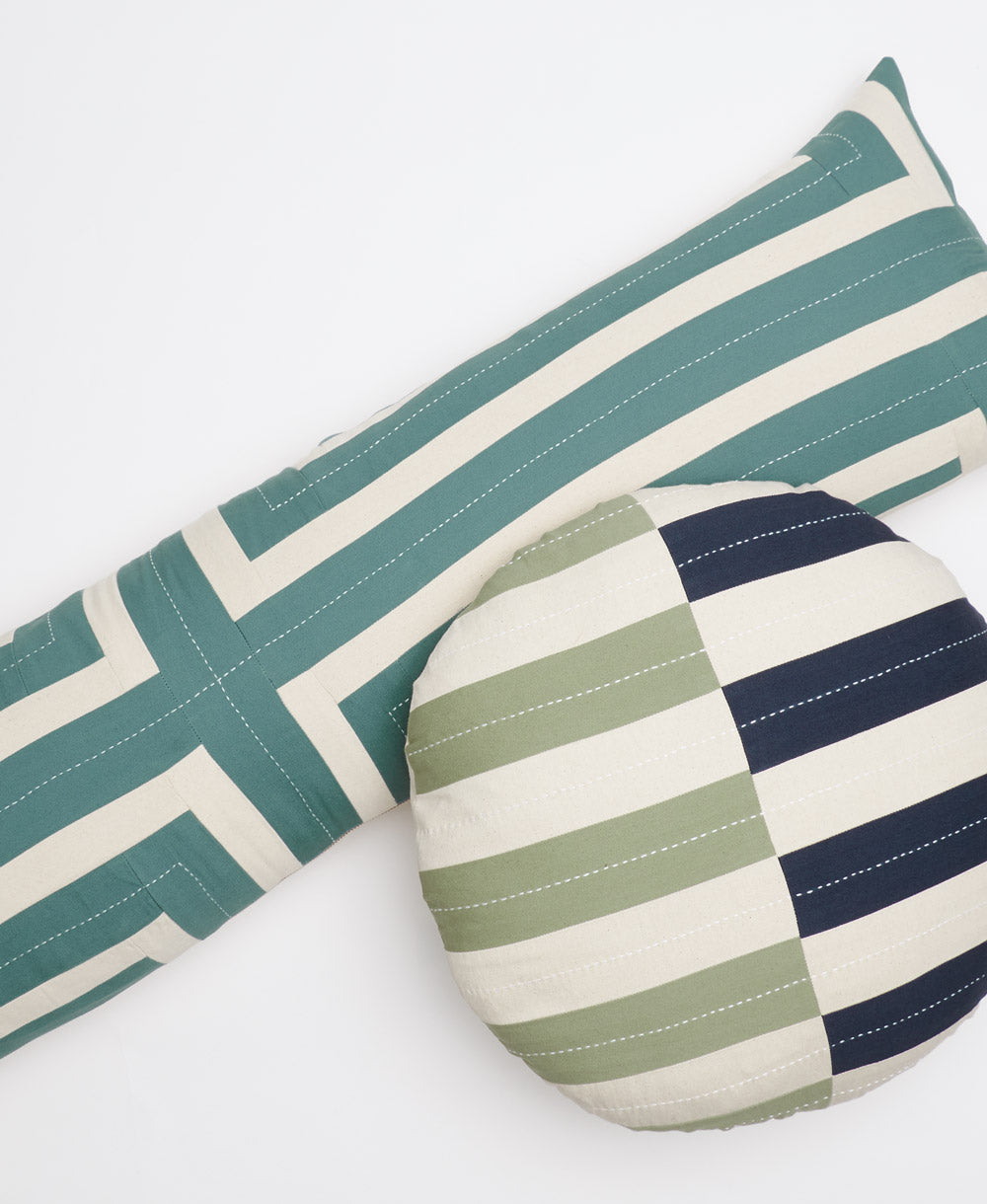 long lumbar throw pillow in spruce green striped with a round throw pillow in navy blue and sage green stripes