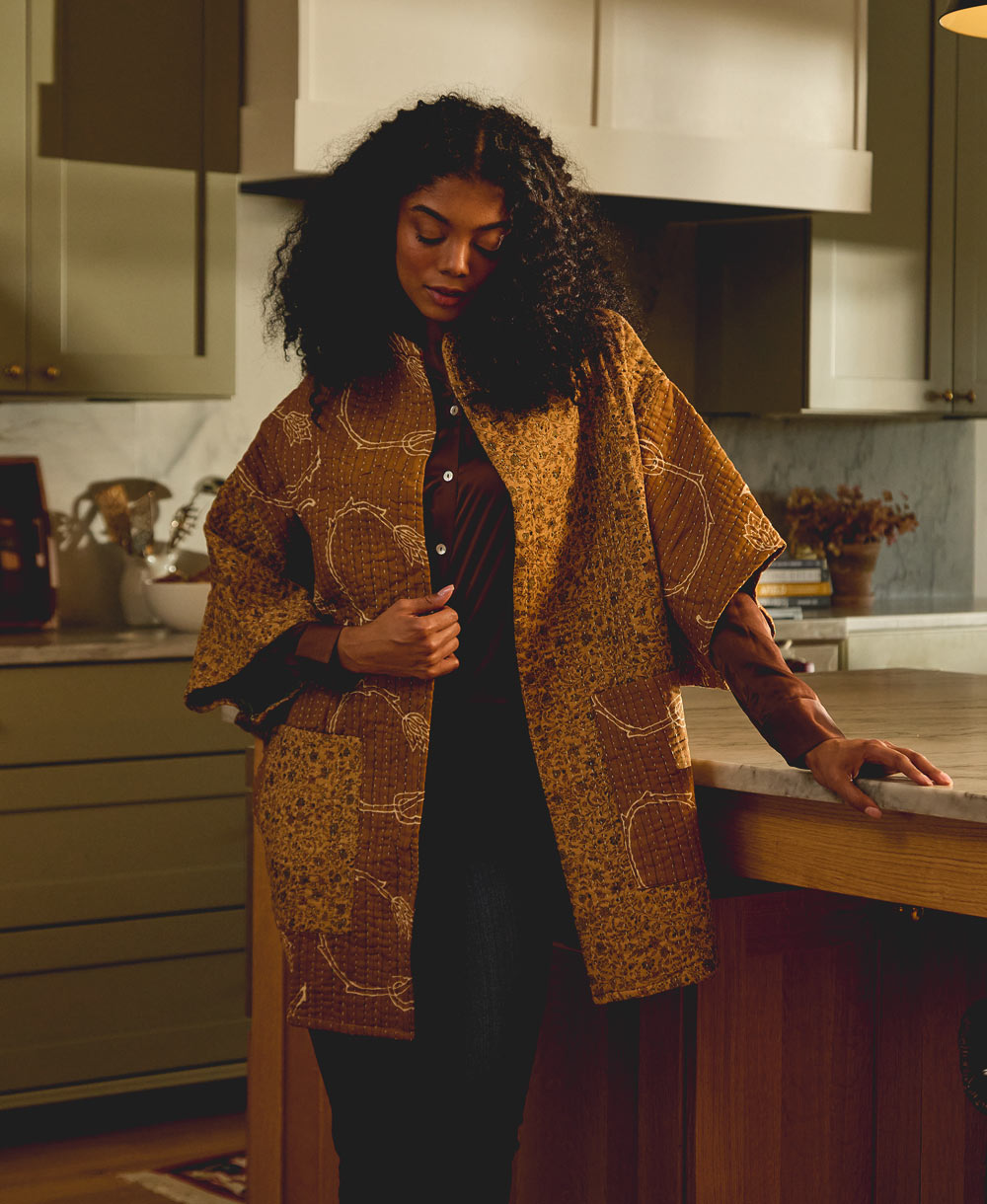 woman in cocoon quilted jacket in a one-of-a-kind brown print handmade in India