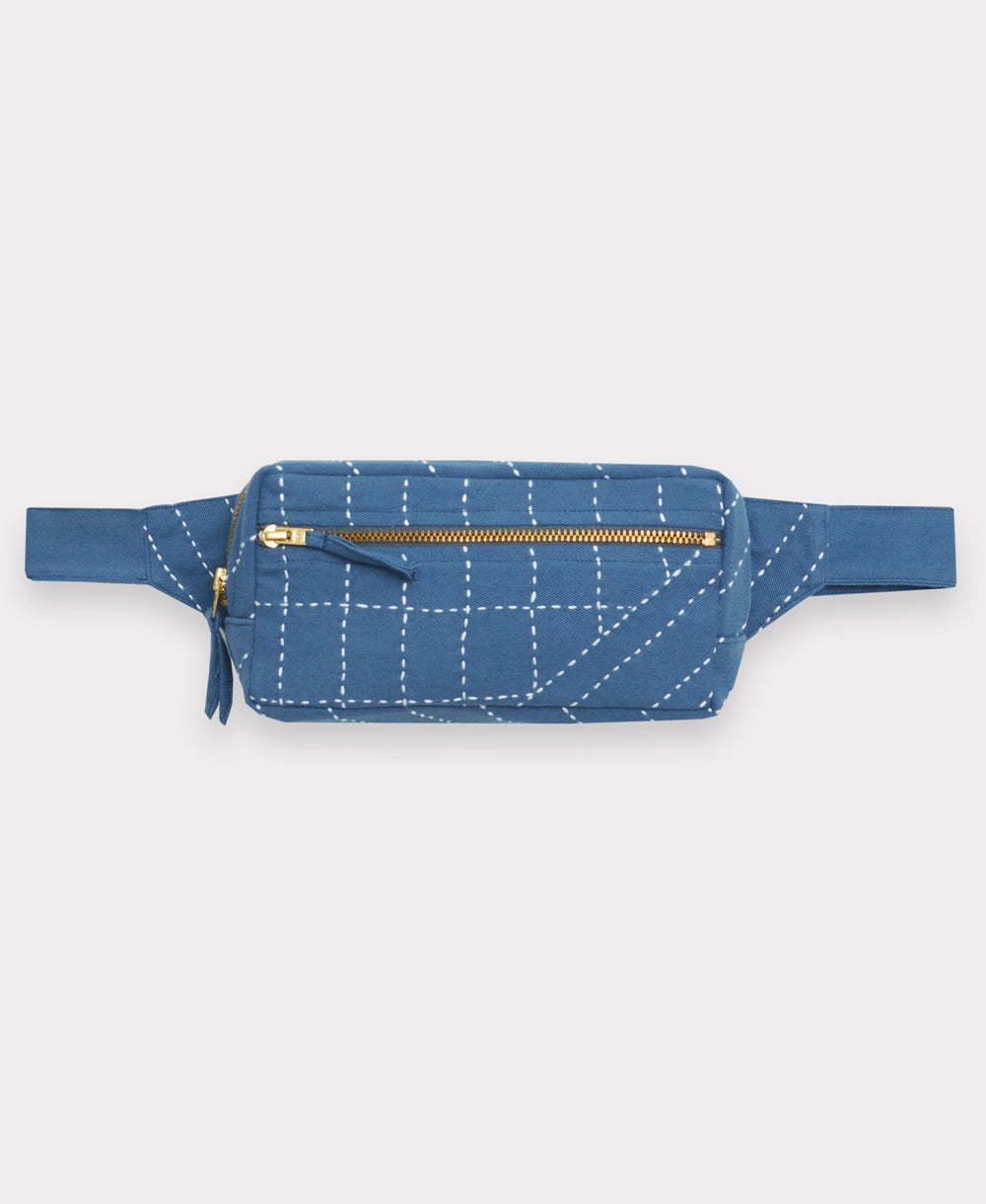 Blue waist bag with white stitching on a light gray background