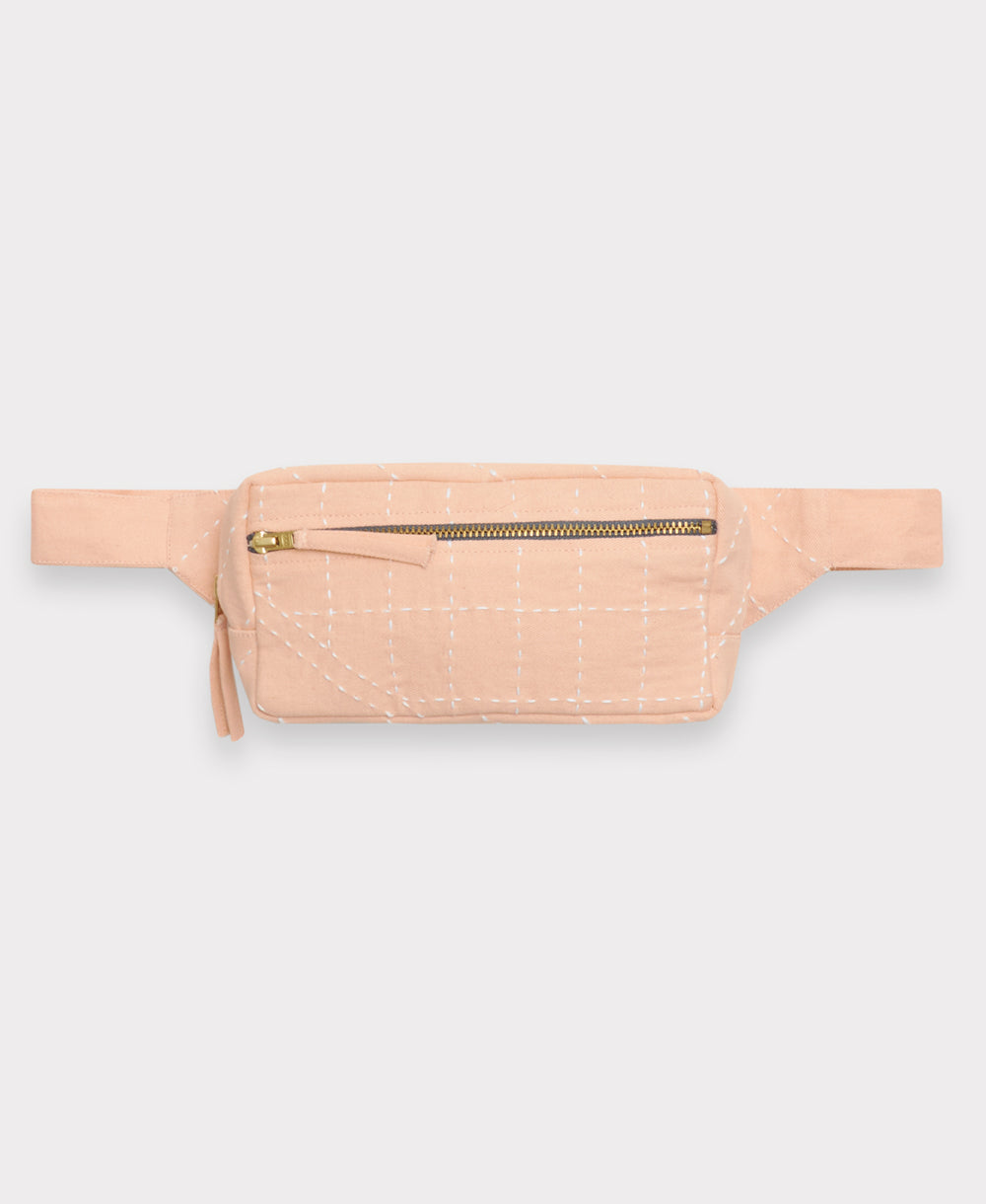 Pink waist bag with a gold zipper on a light gray background