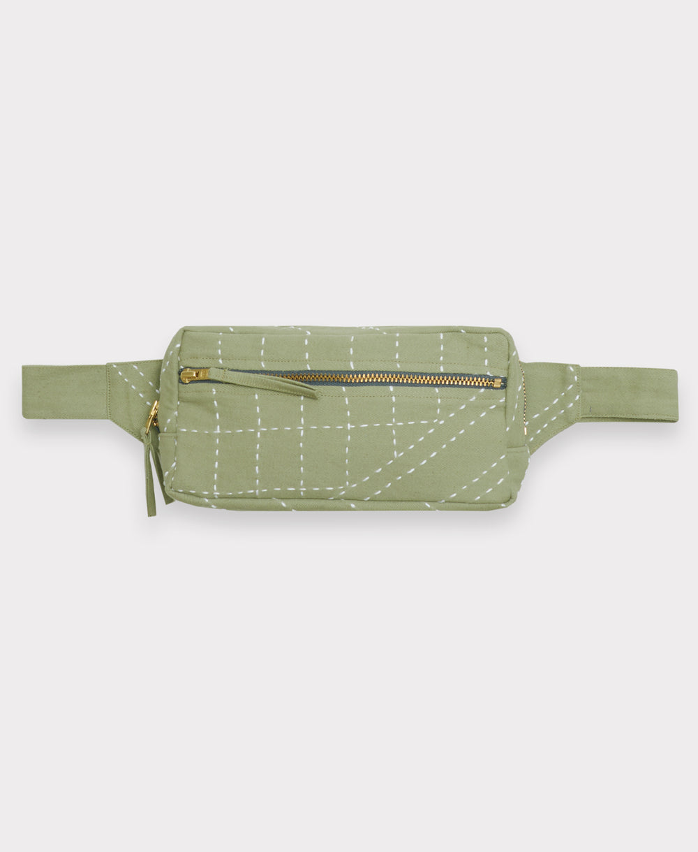 Green waist bag with white stitching on a light gray background