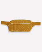 ochre yellow belt bag with white stitching on a light beige background
