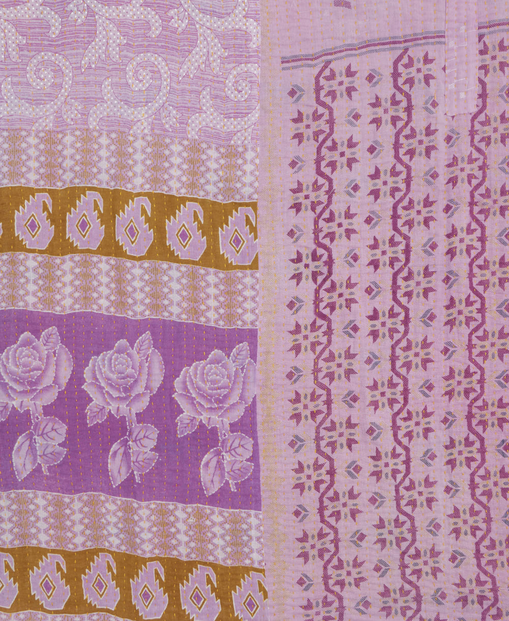 kantha quilt throw with a tag featuring the hand-stitched signature of the maker