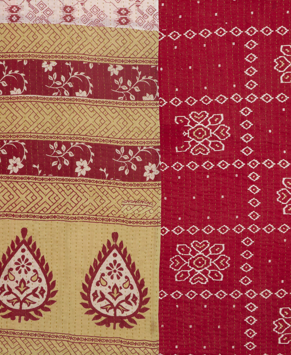 kantha quilt throw with a tag featuring the hand-stitched signature of the maker