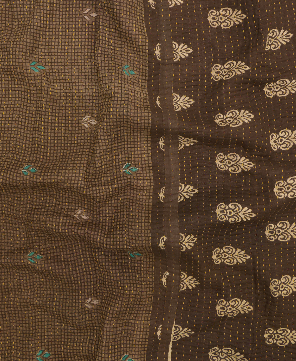 kantha quilt throw with a tag featuring the hand-stitched signature of the maker