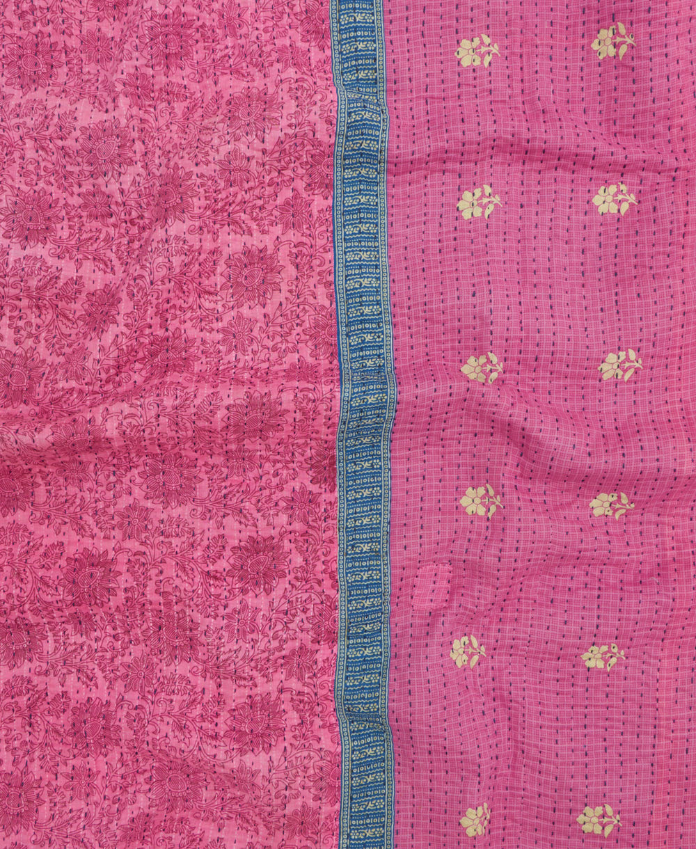 kantha quilt throw with a tag featuring the hand-stitched signature of the maker
