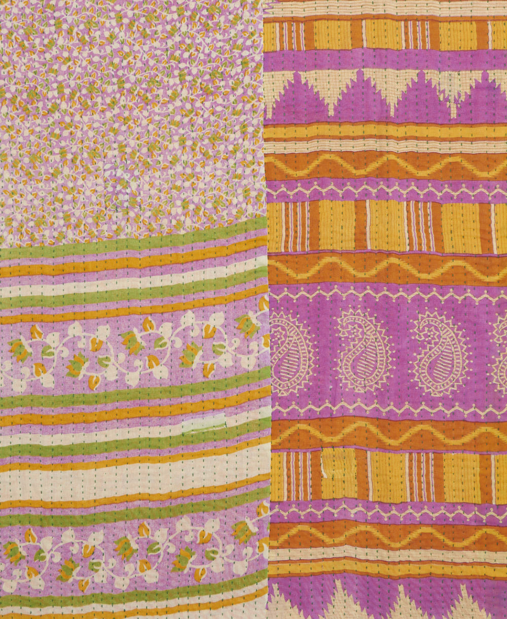 kantha quilt throw with a tag featuring the hand-stitched signature of the maker