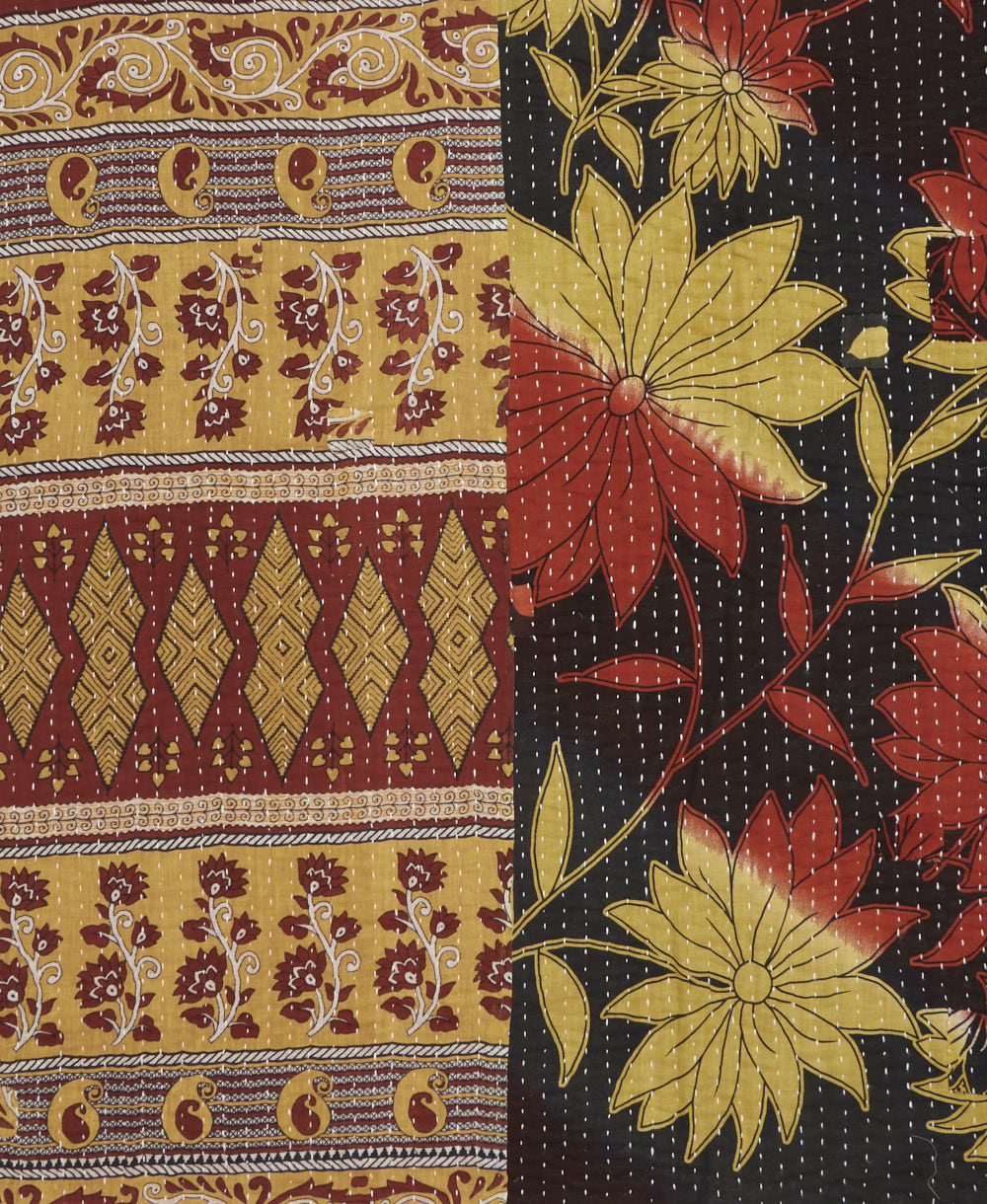 kantha quilt throw with a tag featuring the hand-stitched signature of the maker