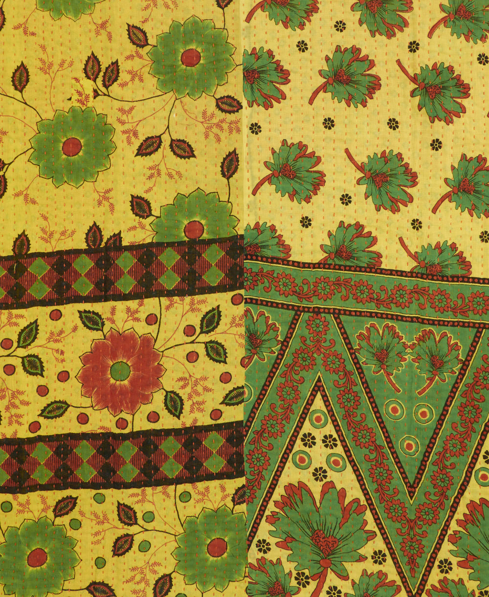 kantha quilt throw with a tag featuring the hand-stitched signature of the maker