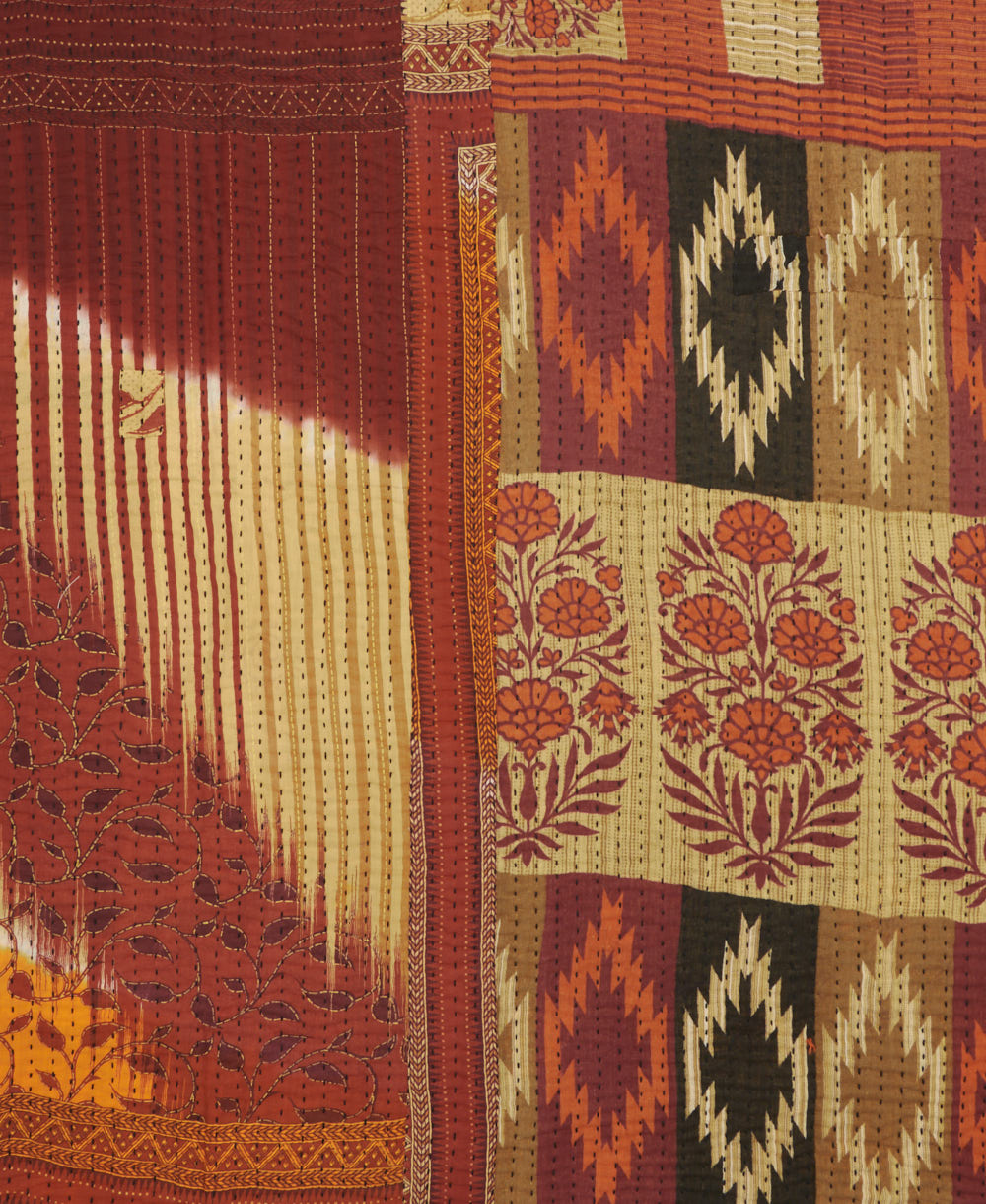kantha quilt throw with a tag featuring the hand-stitched signature of the maker