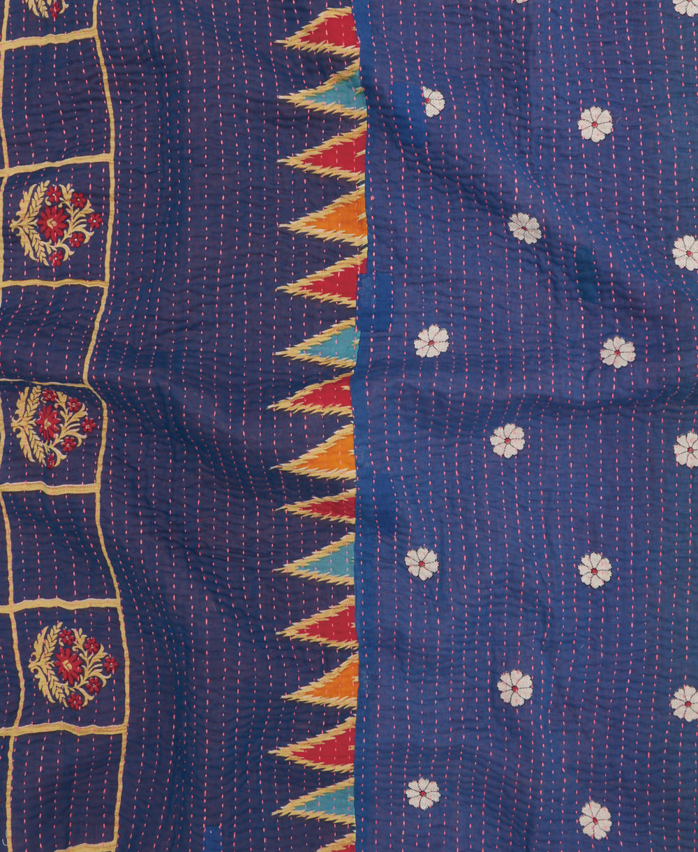 kantha quilt throw with a tag featuring the hand-stitched signature of the maker