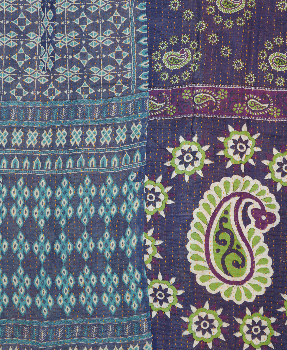 kantha quilt throw with a tag featuring the hand-stitched signature of the maker