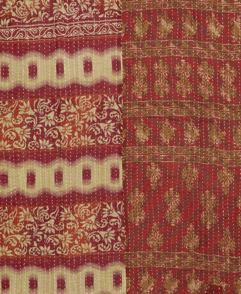 kantha quilt throw with a tag featuring the hand-stitched signature of the maker