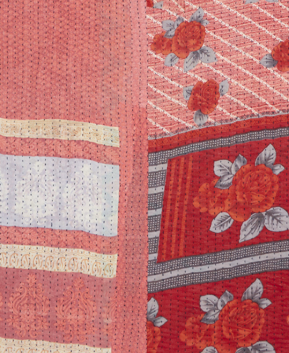 kantha quilt throw with a tag featuring the hand-stitched signature of the maker