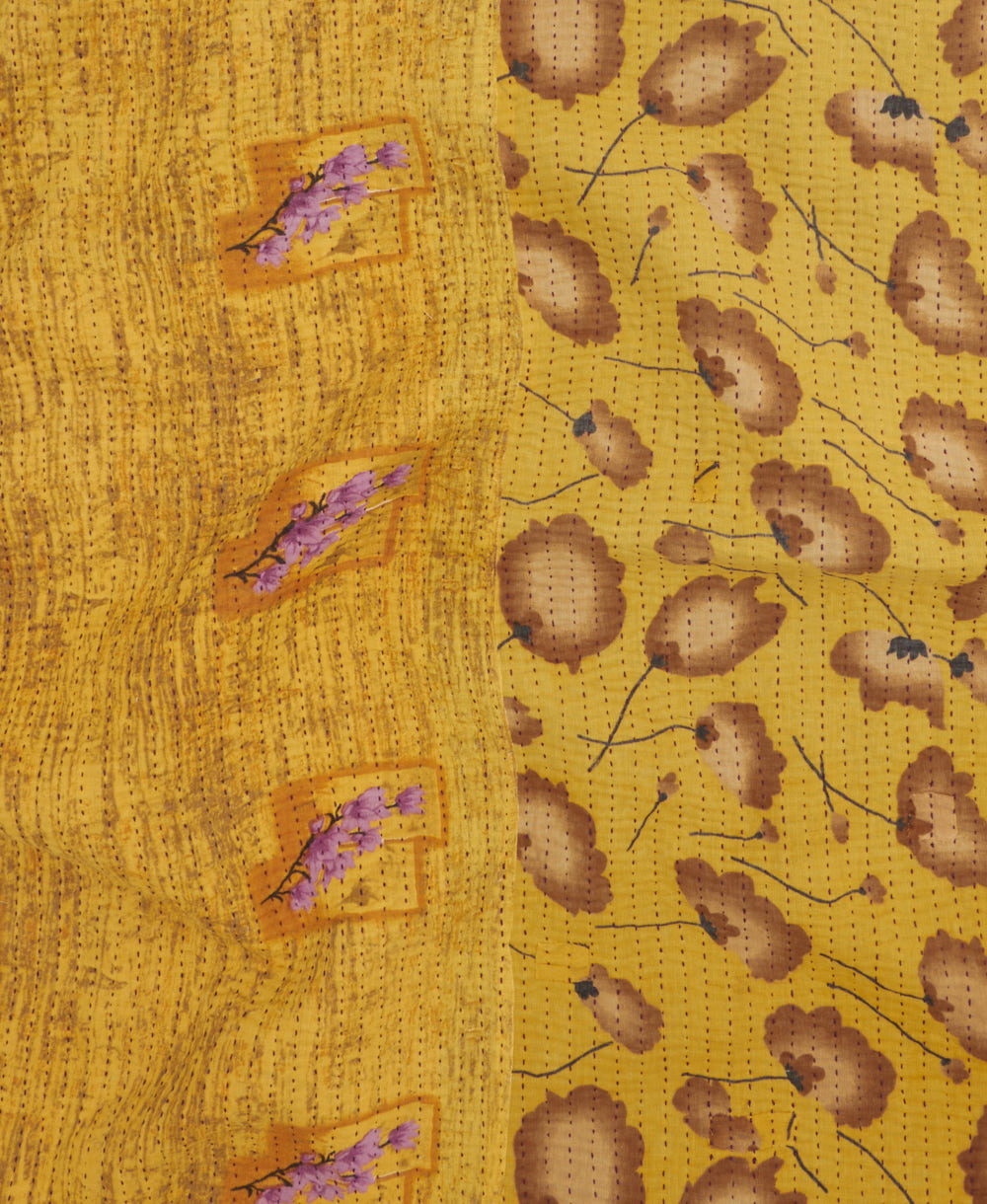 kantha quilt throw with a tag featuring the hand-stitched signature of the maker