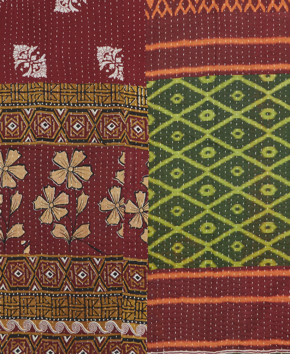 kantha quilt throw with a tag featuring the hand-stitched signature of the maker