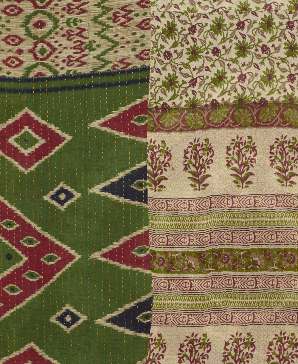 kantha quilt throw with a tag featuring the hand-stitched signature of the maker