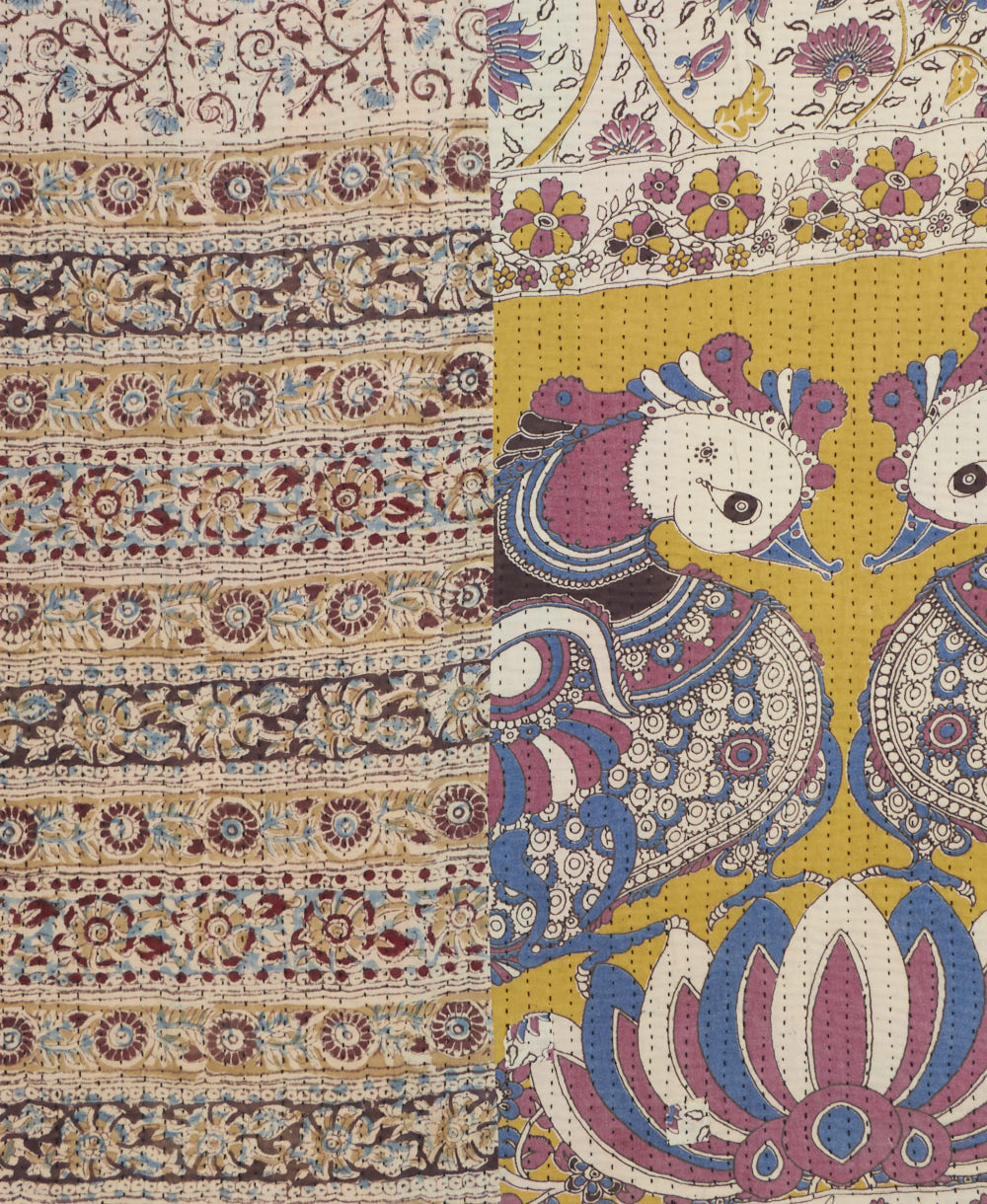 kantha quilt throw with a tag featuring the hand-stitched signature of the maker