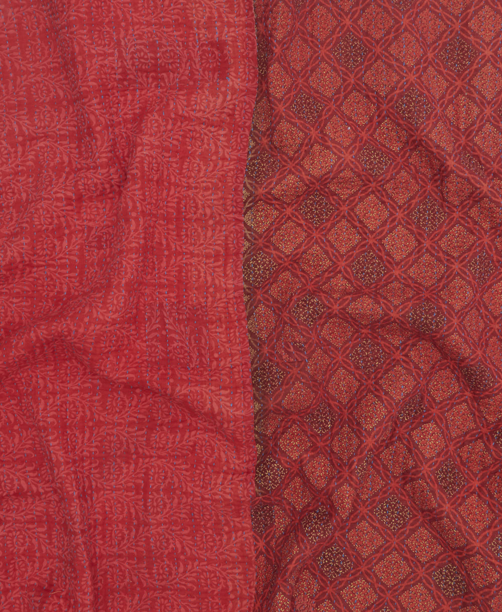 kantha quilt throw with a tag featuring the hand-stitched signature of the maker