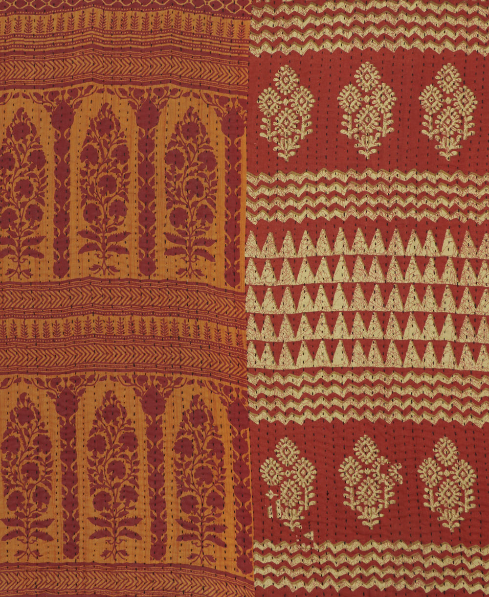 kantha quilt throw with a tag featuring the hand-stitched signature of the maker