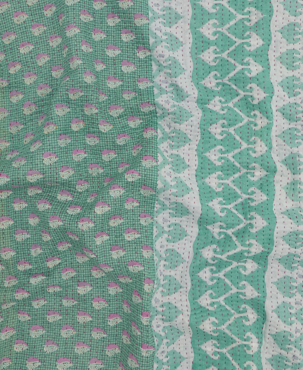 kantha quilt throw with a tag featuring the hand-stitched signature of the maker