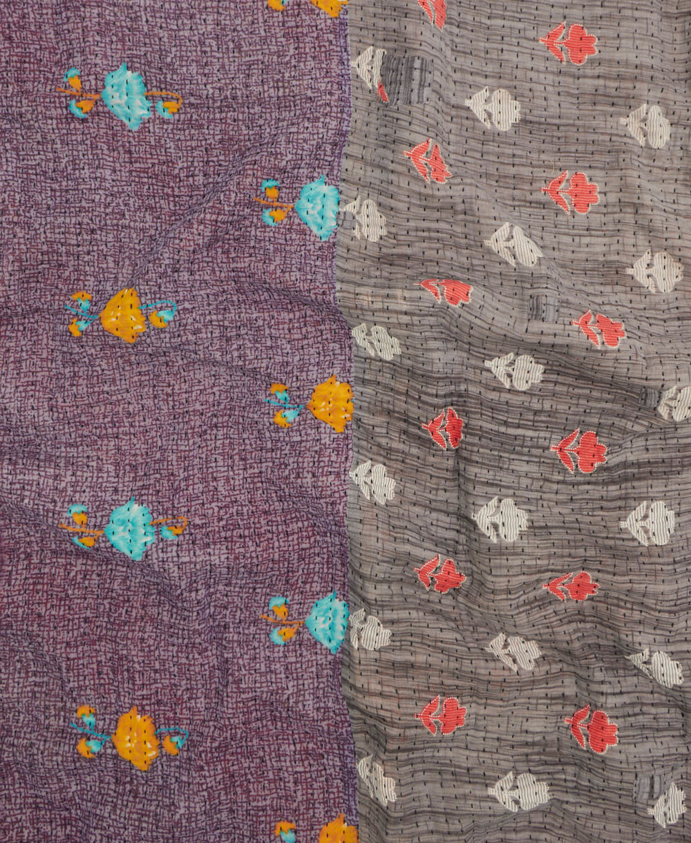 kantha quilt throw with a tag featuring the hand-stitched signature of the maker