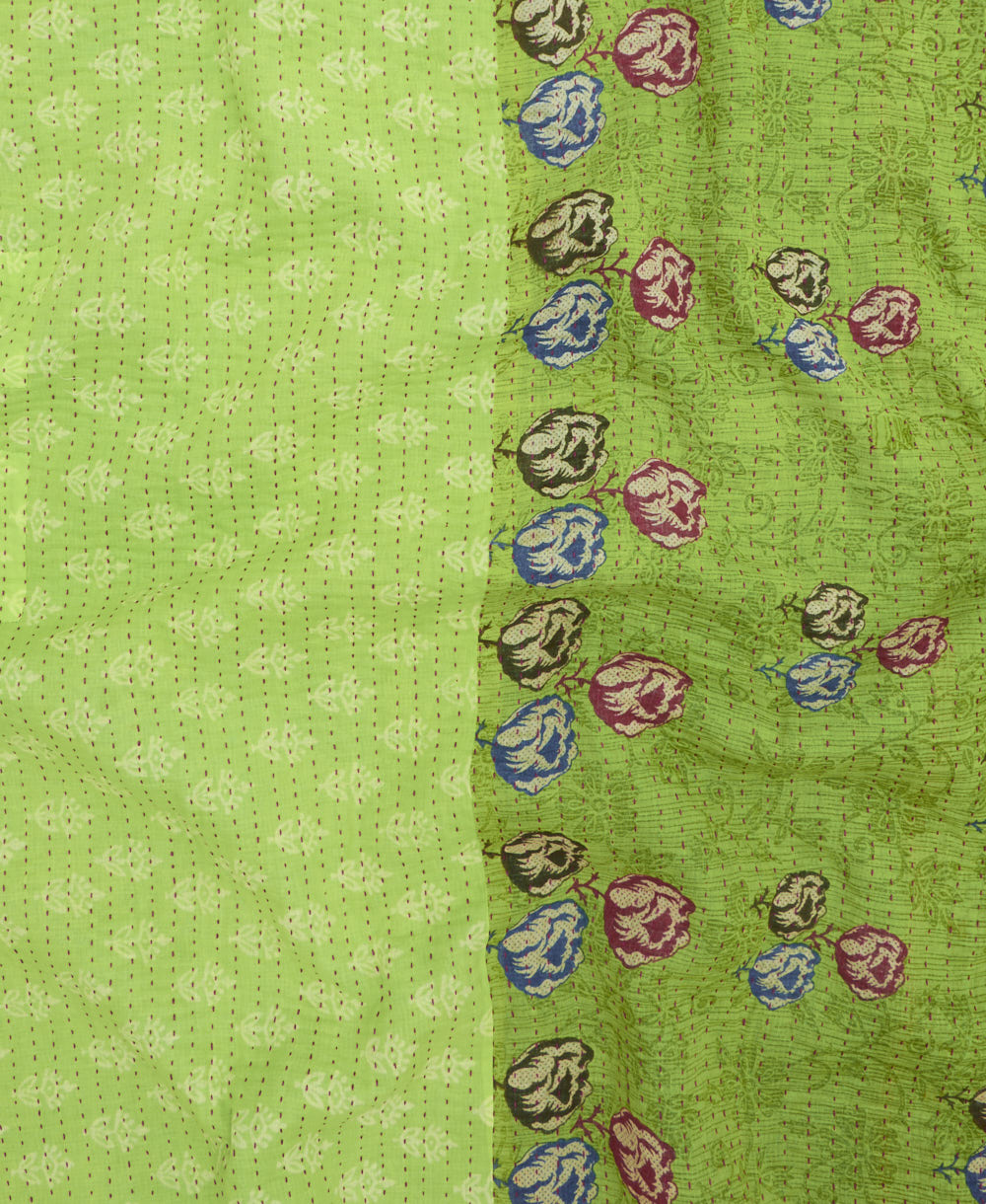 kantha quilt throw with a tag featuring the hand-stitched signature of the maker