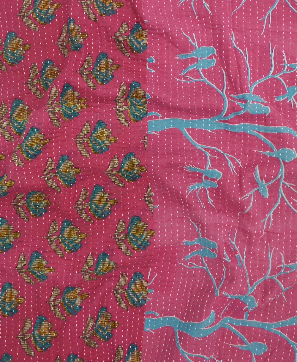 kantha quilt throw with a tag featuring the hand-stitched signature of the maker