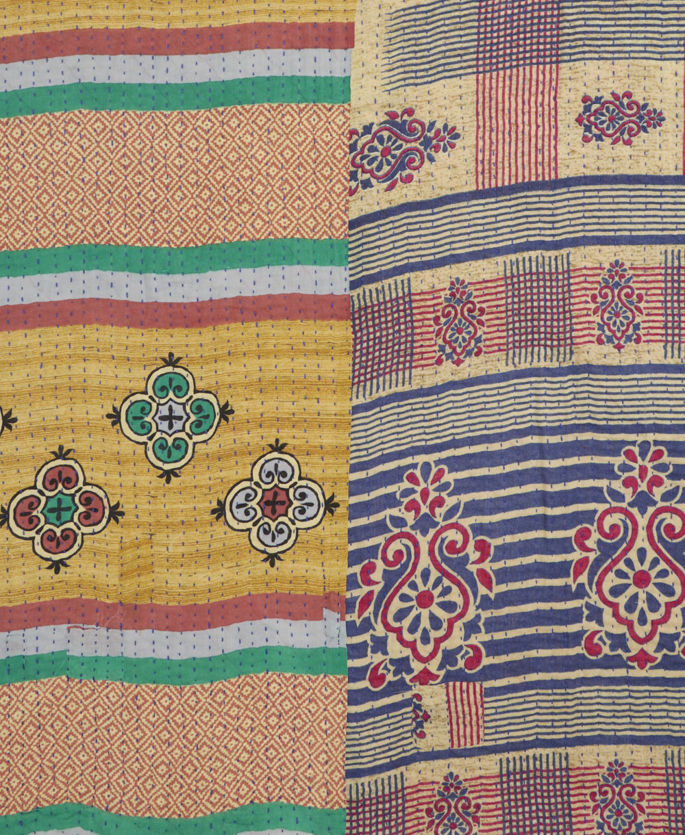kantha quilt throw with a tag featuring the hand-stitched signature of the maker