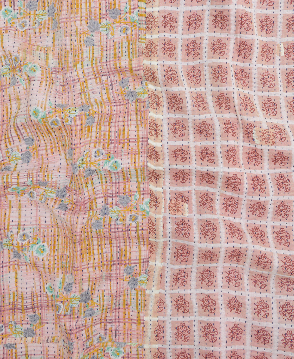 kantha quilt throw with a tag featuring the hand-stitched signature of the maker