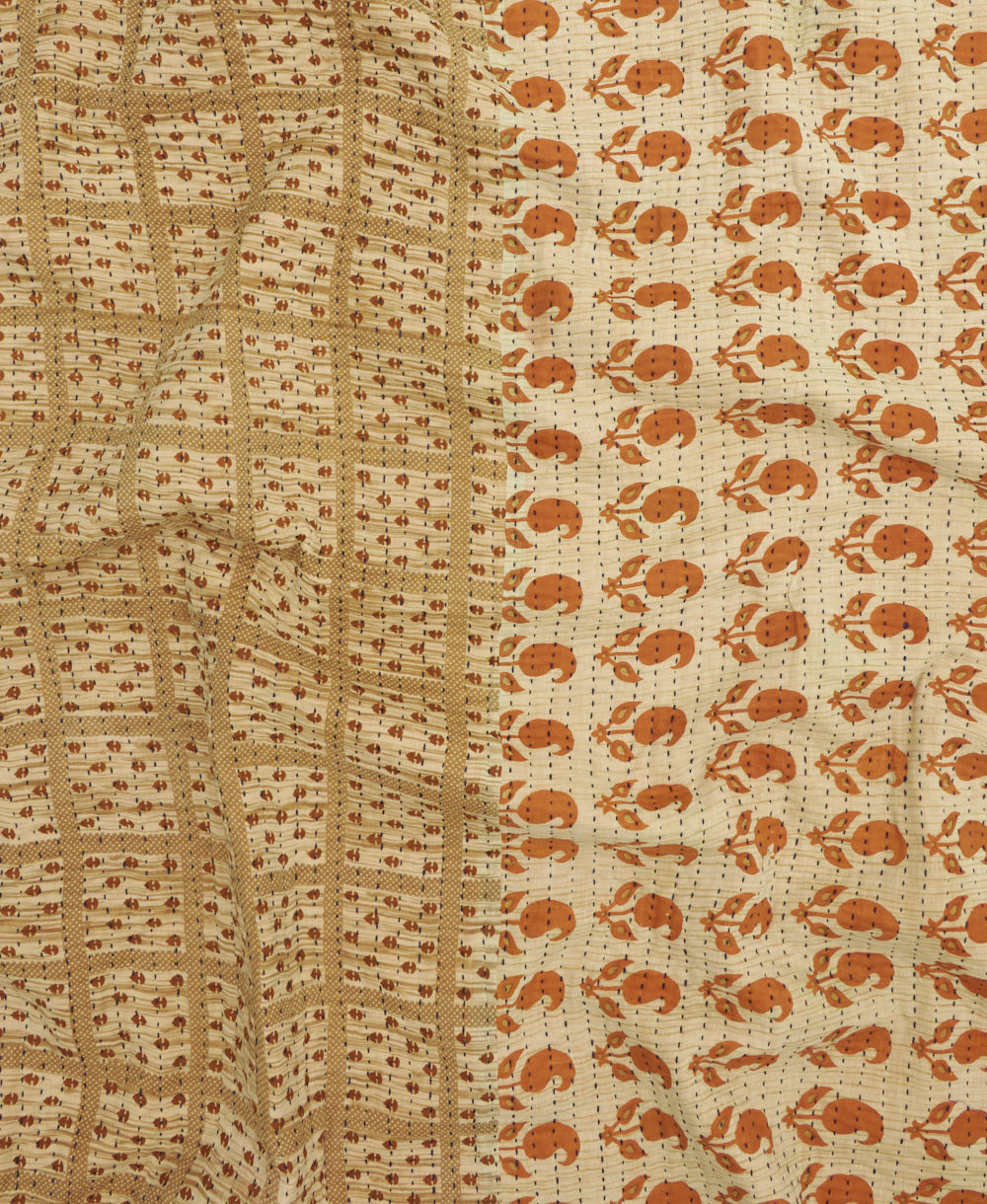 kantha quilt throw with a tag featuring the hand-stitched signature of the maker